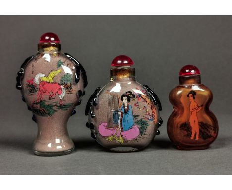 A collection of three fantastic inside-painted glass snuff bottles; the first one decorated with two galoping horses and the 