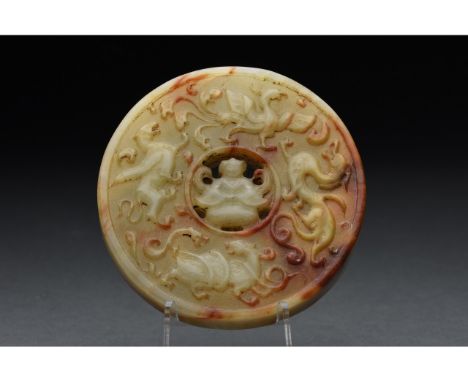 Ca.1644-1911; Qing dynasty or earlier. A fantastic example of bi-disc made of a pale-green jade with some natural red layers;