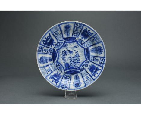 Qing dynasty; Kangxi period (1662-1722AD); An interesting blue and white glazed ceramic plate with a central panel depicting 