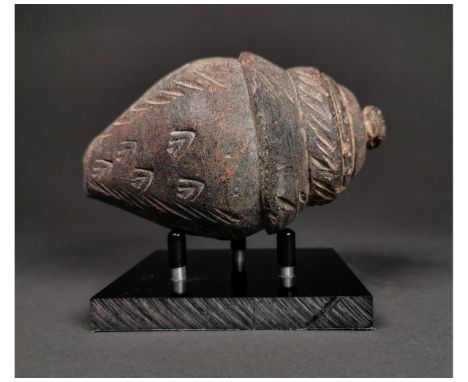 Ca.800 AD. A hollow ceramic Vessel with a barrel-shaped body, domed top, and conical base, knop to the upper face for the mou