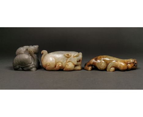 Ca.20th C AD or earlier. Three beautifully carved jadeite ornaments rapresenting Chinese mythical beasts; a grey colored jade