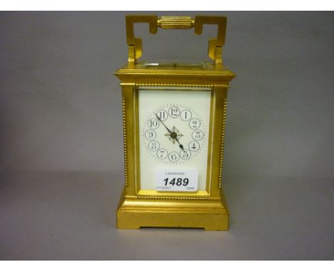 late 19th / early 20th Century matt gilded brass cased carriage clock, the enamel dial with Arabic numerals, the two train mo