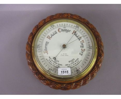 Large late 19th / early 20th Century circular carved oak aneroid barometer with a rope pattern case