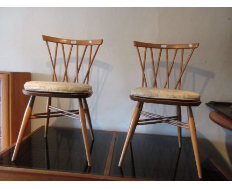 Set of three Ercol pale beech and elm kitchen chairs with stick backs and panel seats on turned supports together with a repr