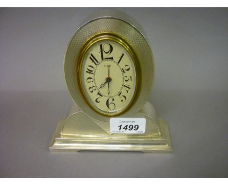 Continental silver (900 mark) mantel or dressing table clock of Art Deco design with an oval dial, Arabic numerals and alarm 