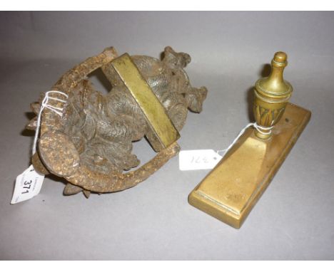 Antique brass door stopper and a cast iron door knocker, dated to the back