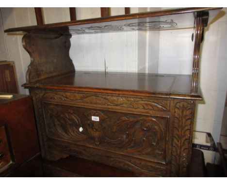 20th Century oak monks bench having carved panel front with hinged box seat