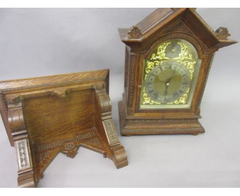 Edwardian carved oak bracket clock with matching bracket, the architectural Gothic style case enclosing a brass dial with sil
