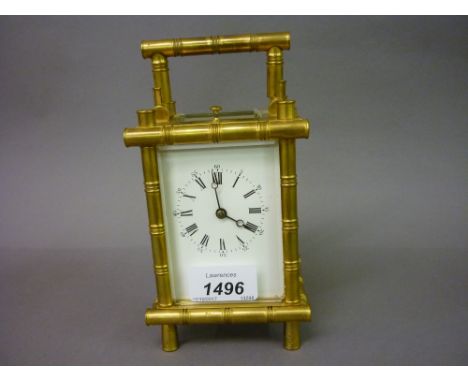 Early 20th Century gilt brass carriage clock of simulated bamboo design, the enamel dial with Roman and Arabic numerals, the 