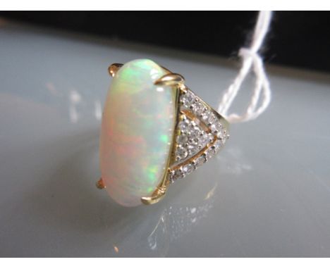 18ct Yellow gold long oval, opal and diamond ring, the opal of approximately 6.02ct, diamonds of approximately 0.65ct total