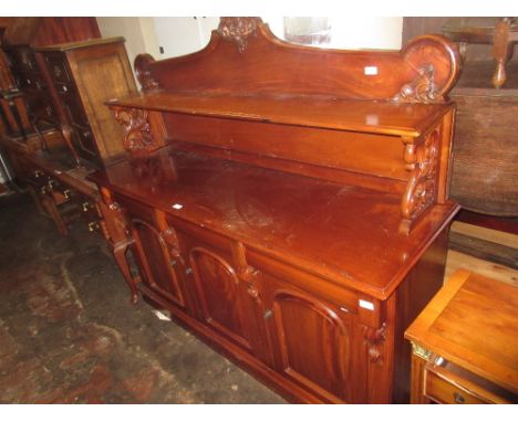 Reproduction mahogany chiffonier, the shelf back with carved surmount above three drawers and three dome topped panelled door