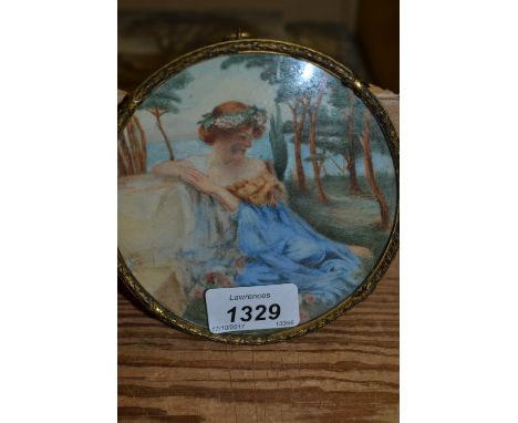Circular miniature watercolour on ivory, portrait of a seated girl in garden scene, in a gilt metal frame