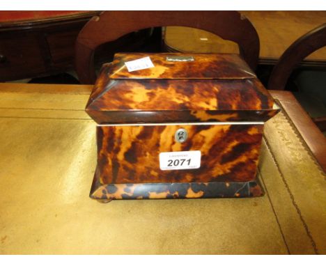 Early 19th Century two division tortoiseshell tea caddy of tapering sarcophagus form on bun feet