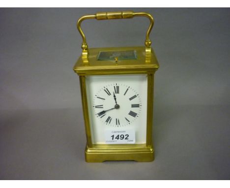 Early 20th Century gilt brass carriage clock, the enamel dial with Roman numerals and a two train quarter repeat function mov