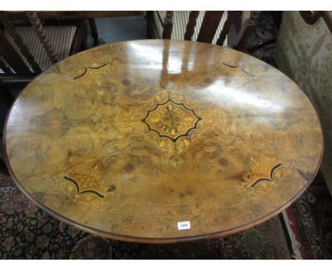 19th Century burr walnut oval inlaid loo table on four column support with swept carved legs and brass and ceramic casters, 3