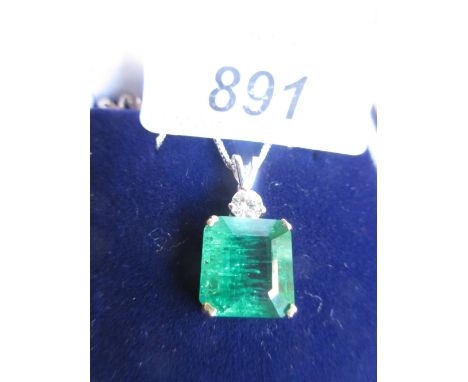 18ct Yellow gold emerald and diamond pendant, the emerald of approximately of 6.4ct on a 14ct white gold chain