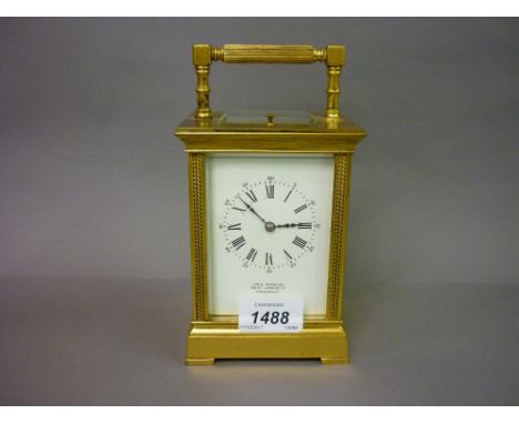 Late 19th / early 20th Century matt gilded brass carriage clock, the enamel dial with Roman and Arabic numerals, signed John 