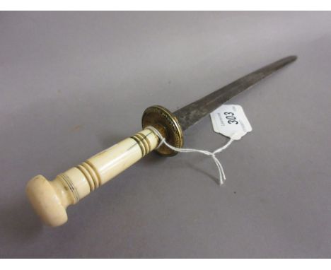 Antique double edged steel dagger with a gilt metal hilt and turned ivory grip