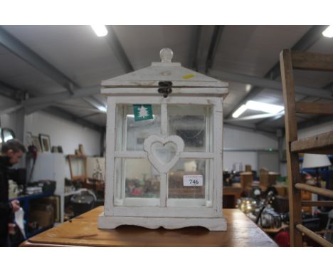 A wooden and glass candle lantern