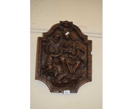 A carved relief wall panel