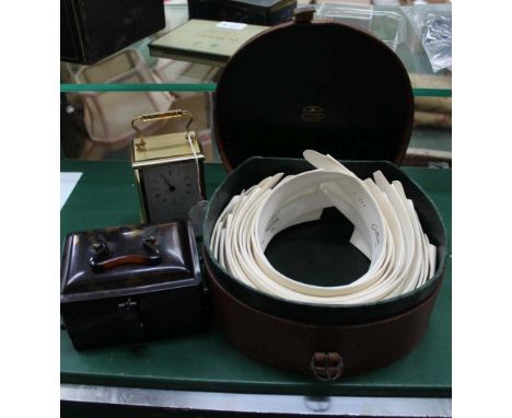 A TRADITIONAL DESIGN CARRIAGE CLOCK together with; a leather collar box, plus contents, and a tortoiseshell effect cantilever