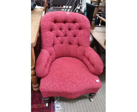 A RE-UPHOLSTERED VICTORIAN BUTTON BACK DEEP SEATED ARMCHAIR on turned show wood legs with white ceramic castors 
