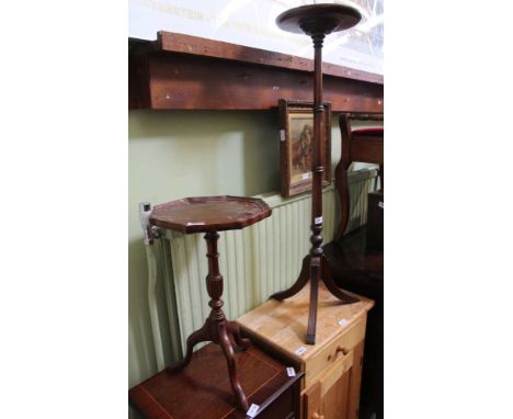 A REPRODUCTION CIRCULAR TOPPED PLANT STAND together with a reproduction piecrust edged wine table 