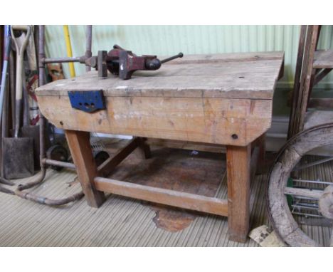 A CHILD'S SIZED SOFTWOOD WORK BENCH together with a metal bench vice 