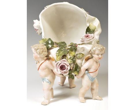 A 19th Century German Sitzendorf floral encrusted winged cherub / putti porcelain table salt pig. Raised on putti with a flor