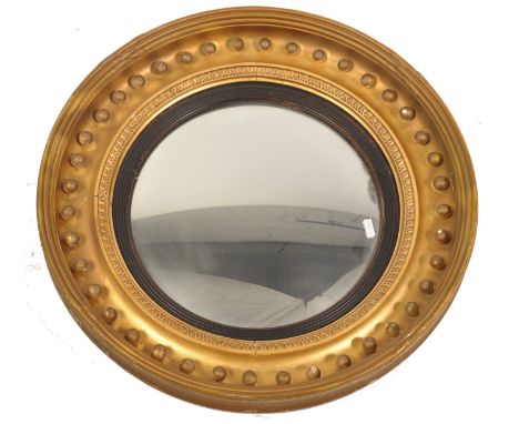 A large 19th century Regency giltwood convex wall mirror. Of circular form&nbsp; with ball finial plaster embellishments to t