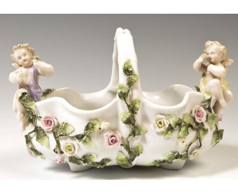 A 19th Century German Sitzendorf floral encrusted winged cherub / putti porcelain bon bon basket. Winged putti to either end 