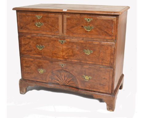 An 18th century George 1st burr walnut and oak chest of drawers. Raised on bracket feet with a short and deep drawer configur