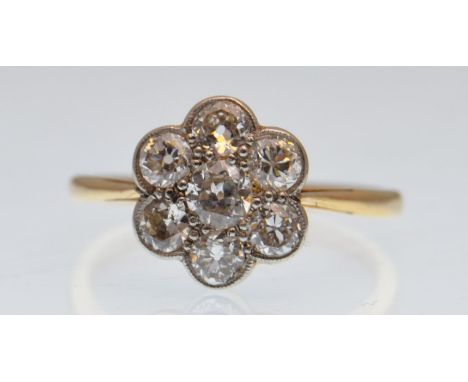 An 18ct gold platinum diamond cluster ring. The ring having round cut diamonds in a cluster setting. Estimated diamond weight