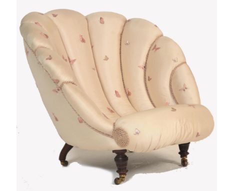 A Victorian 19th century clam shell armchair / chair. Raised on mahogany turned legs terminating in ceramic brown castors. Ab