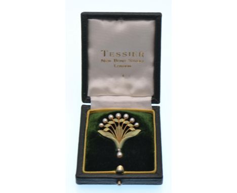 An early 20th century 18ct gold diamond cultured pearl and enamel pendant spray brooch. The brooch depicting a green enamel f
