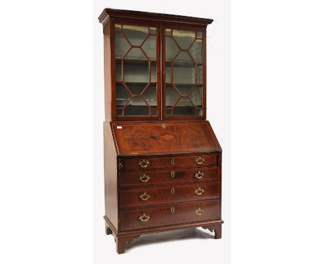 A George III 18th century mahogany and marquetry inlaid cross-banded bureau bookcase. Raised on bracket feet with a bank of d