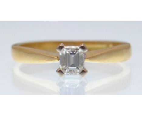 A hallmarked 18ct gold and diamond solitaire ring having an emerald cut diamond of approx 50pts. Weight 3.54g. Size K.