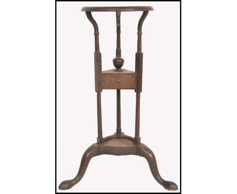 A 19th century George III mahogany washstand, circa 1800 being raised on&nbsp; turned columns and splayed legs with lower tie