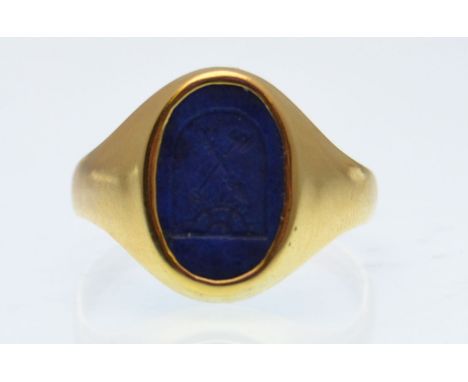 A lapis lazuli and gold intaglio seal ring. The ring being set with on oval intaglio lapis lazuli seal. Unmarked. Weight 3.6g