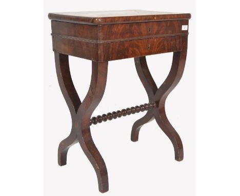 A 19th century continental walnut Biedermeier ladies vanity workbox table. Raised on cross over&nbsp; lyre shaped supports un