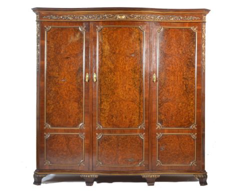 A Victorian 19th century rosewood serpentine fronted Maple &amp; Co triple compactum wardrobe. Raised on bracket feet with an