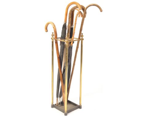 A Victorian 19th century brass stick stand of square form. Raised on cast iron drip tray base with tubular upright frame with