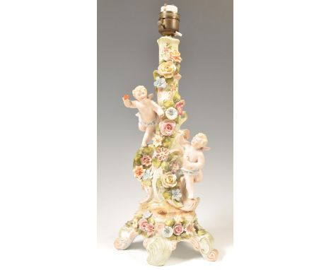 A 19th Century Meissen / Sitzendorf floral encrusted winged cherub / putti porcelain table lamp&nbsp; in the form of a floral