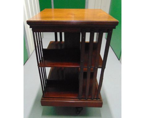 A Mahogany rotating rectangular two level book shelf with pierced slatted sides, A/F, 85.5 x 40.5 x 48.5cm