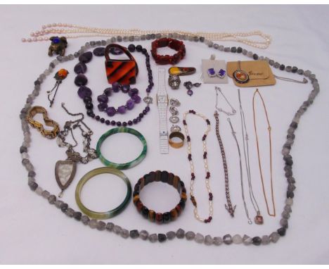 A quantity of costume jewellery to include necklaces, jade bangle, bracelets, earrings and a ring