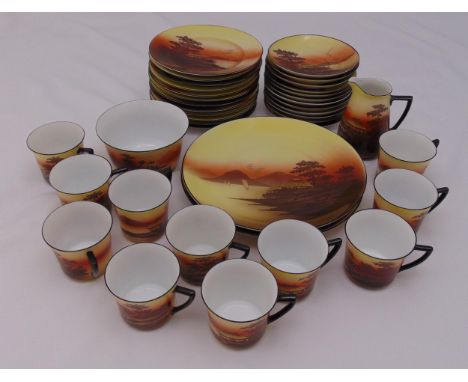 A continental teaset for twelve place settings, to include cups, saucers, plates, cake plates, sugar bowl and milk jug, beehi