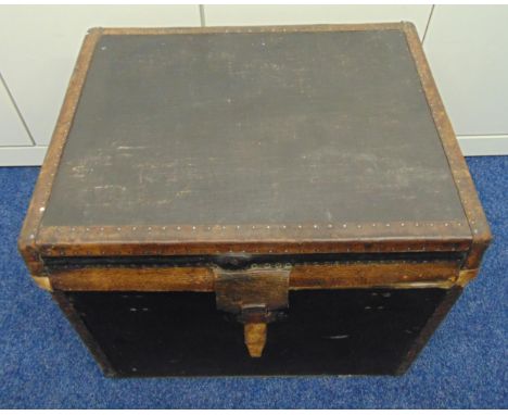 A rectangular leather bound trunk with studded hinged cover to reveal lined interior