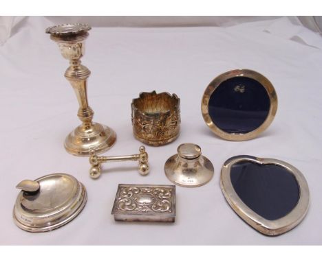 A quantity of hallmarked silver and white metal to include photograph frames, an inkwell and a candlestick