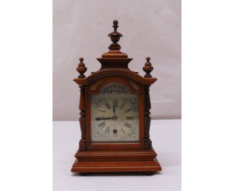 A German Black Forest mantle clock silvered dial, Roman numerals, single train movement, to include key and pendulum, 36cm (h