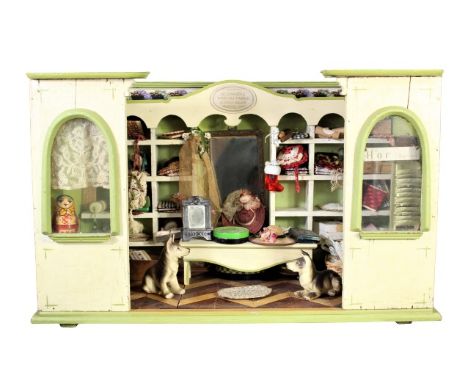 Charming wooden dollhouse with many accoutrements, the sign above the dollhouse is in German and when translated states: 'Whi